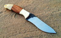 "Close-up view of the bone and rosewood handle of the hunting knife."
