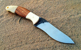 "Close-up view of the bone and rosewood handle of the hunting knife."
