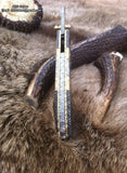 Hand-engraved steel & brass handle on The Artisan's Edge folding pocket knife
