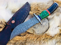 "Close-up of buffalo horn and exotic wood handle on hunting knife."
