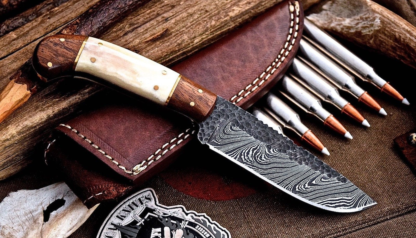 "Intricate patterns of the Damascus steel blade on the custom hunting knife."





