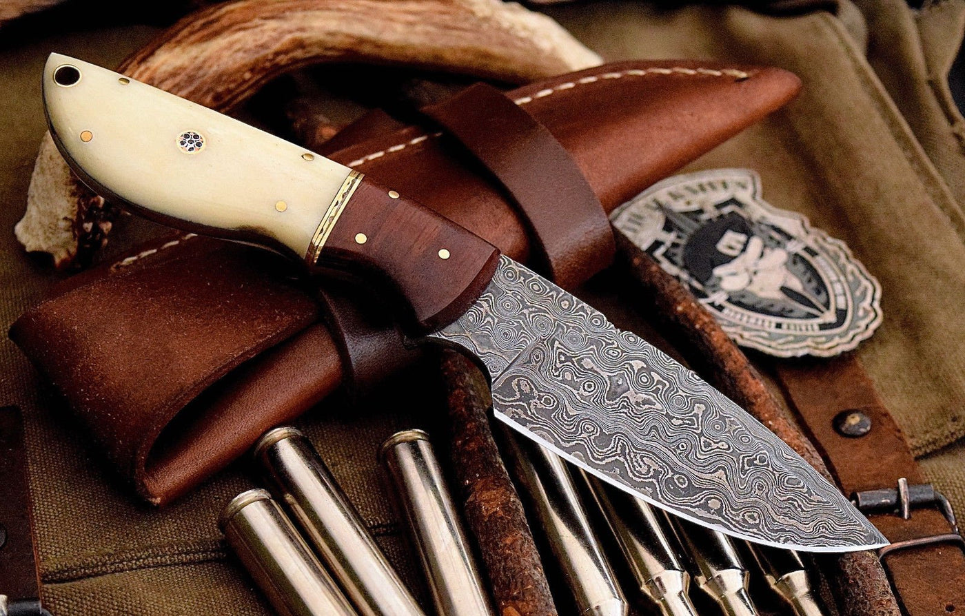 Rosewood and bone handle with brass spacers on custom deer skinning knife.