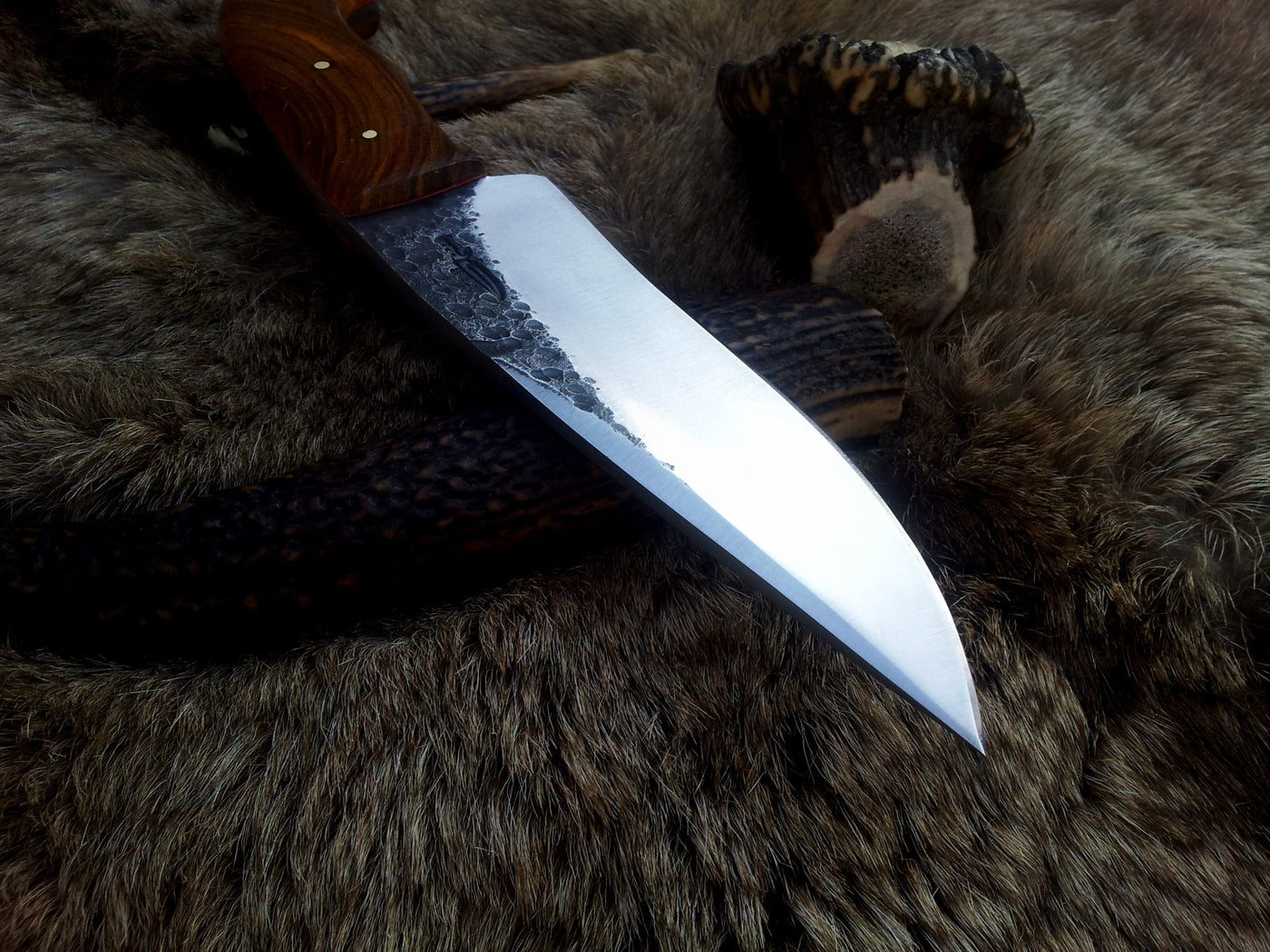 Close-up of 1095 tool steel blade on KBS Knives hand-forged hunting knife
