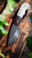 Custom 7.5-inch Damascus steel deer skinning knife with bone and rosewood handle.
