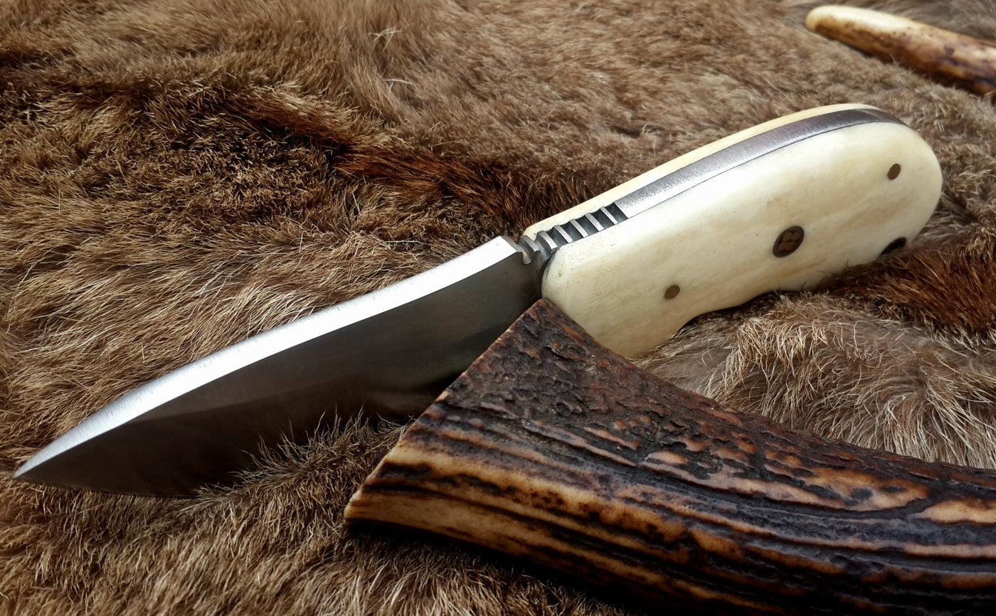 Bone handle of the field dressing knife providing a comfortable grip.

