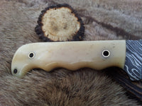 10-inch Damascus steel knife featuring a sharp edge and leather sheath
