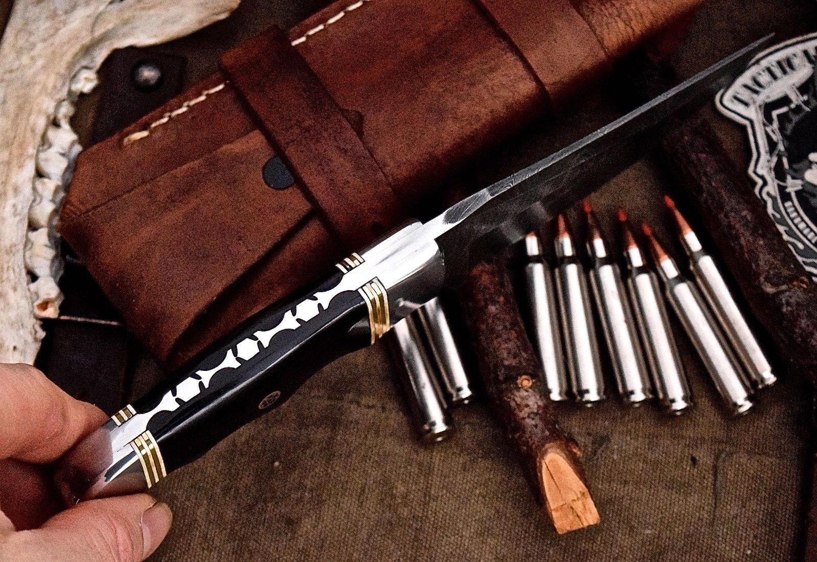 "Full view of the deer hunting knife with its protective leather sheath."
