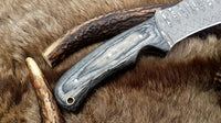 Tactical hunting knife featuring sharp Damascus steel blade
