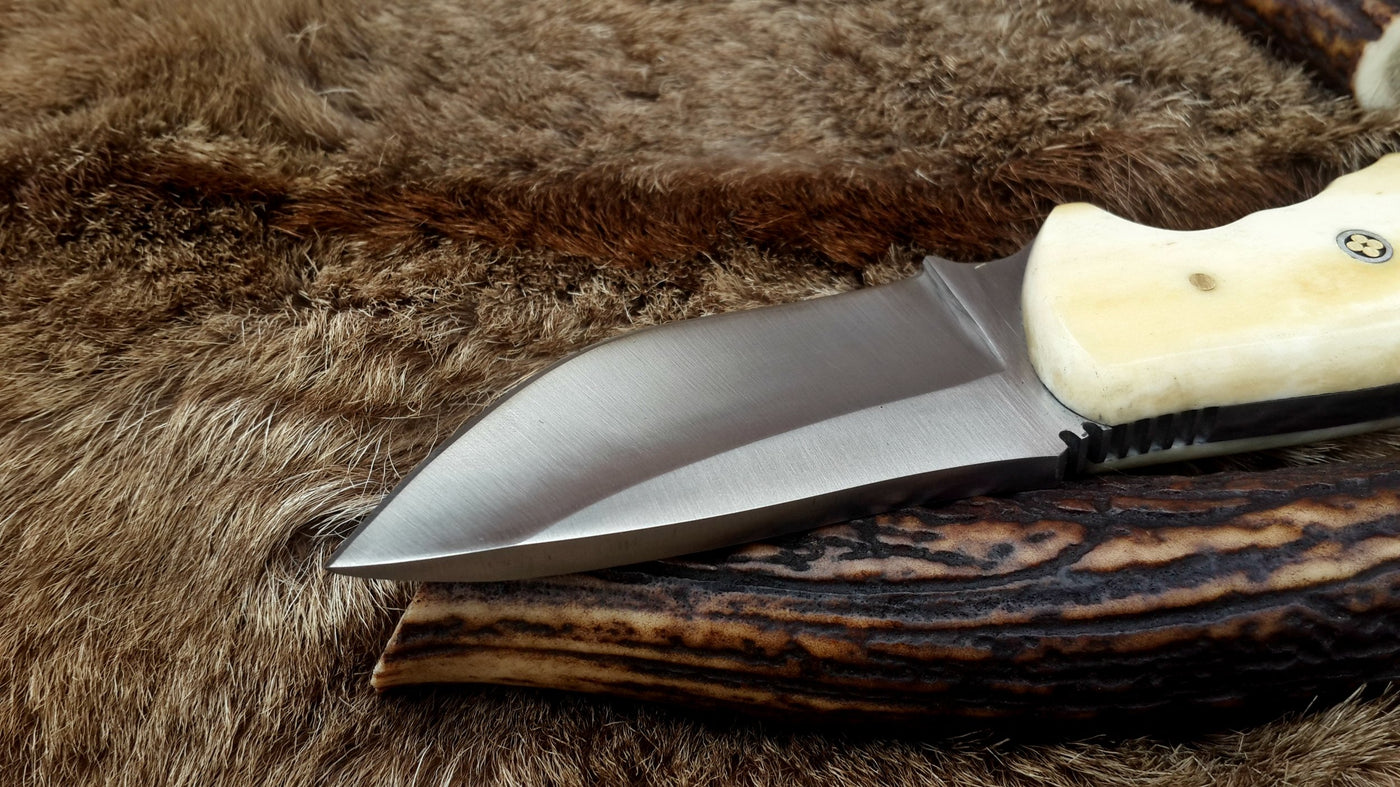 Compact D2 steel deer skinning knife with a 3-inch blade and bone handle.
