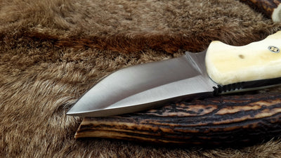 Compact D2 steel deer skinning knife with a 3-inch blade and bone handle.
