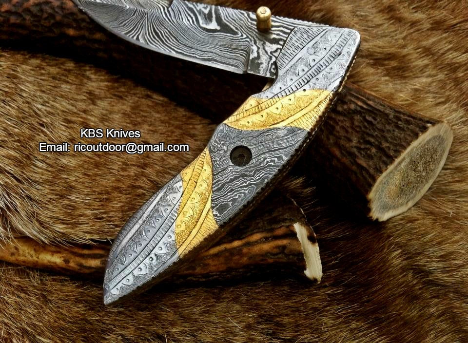 Hand-engraved steel and brass handle on The MasterCraft folding pocket knife
