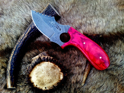 Custom 7.5-inch Damascus steel field dressing knife with Pakka wood handle.
