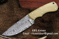 Custom handmade fixed blade skinning knife with a 4-inch Damascus steel blade and bone handle.