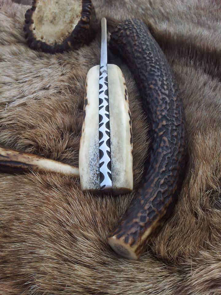 3.5-inch drop point Damascus steel blade on a custom deer skinning knife.
