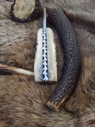 3.5-inch drop point Damascus steel blade on a custom deer skinning knife.
