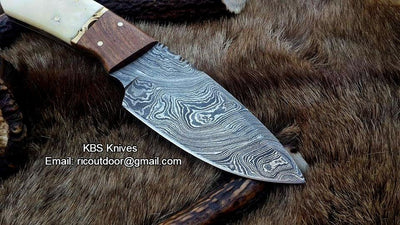Lamb skinner knife with ergonomic bone and rosewood handle featuring a brass spacer.