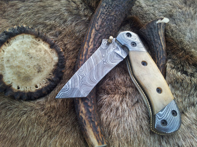 3-inch Damascus steel tanto blade with bone handle and Damascus bolster on The Titan Edge
