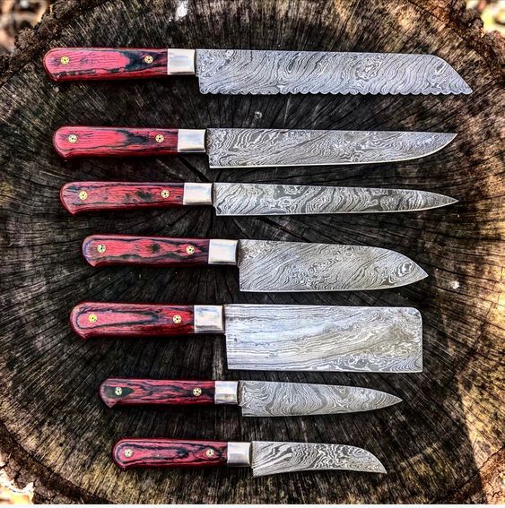 7-piece kitchen knives set with Twist Damascus steel blades, Exotic Wood handles, and steel bolsters, elegantly stored in a leather roll. Culinary sophistication at its finest.