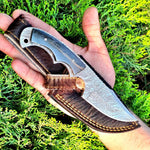 Deer skinning knife with full tang Fire Damascus steel blade and buffalo horn handle.

