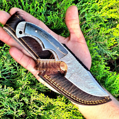 Deer skinning knife with full tang Fire Damascus steel blade and buffalo horn handle.
