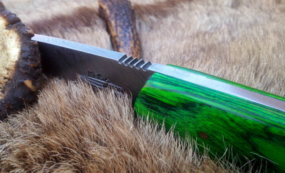 Bushcraft knife being used for cutting wood