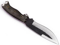Bushcrafter using camp knife for outdoor survival tasks


