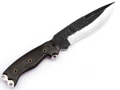 Camp knife being used for cutting wood