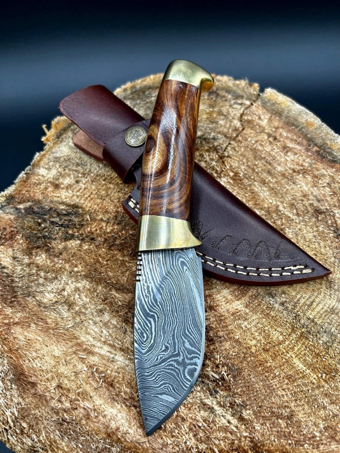 Damascus steel skinning blade with rosewood handle and brass bolsters.
