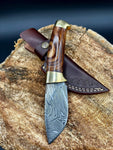 Damascus steel skinning blade with rosewood handle and brass bolsters.
