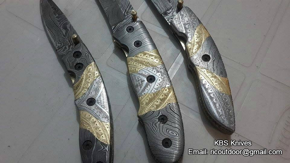 Hand-engraved steel and brass handles on The TriGuard Collection folding pocket knives
