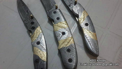 Hand-engraved steel and brass handles on The TriGuard Collection folding pocket knives
