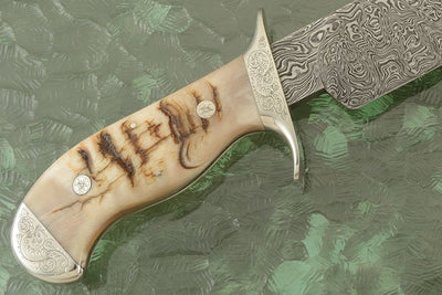 Hand engraved steel guard and bolster on the Tennessee Bowie Knife, offering unique craftsmanship