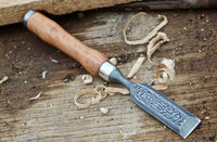 Premium Damascus steel chisel for wood carving displayed on a wooden surface, highlighting its craftsmanship.
