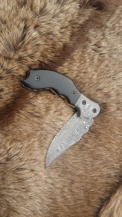 Intricate file work on the liner and spine of The Legacy Damascus Steel Folding Knife

