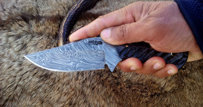 Leather sheath accompanying a custom deer skinning knife with Pakka wood handle and Damascus steel blade.
