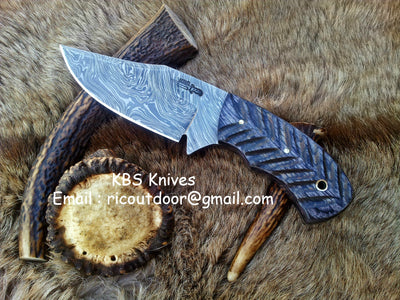 Custom 8.5-inch field dressing deer skinning knife with Damascus steel blade and Pakka wood handle.
