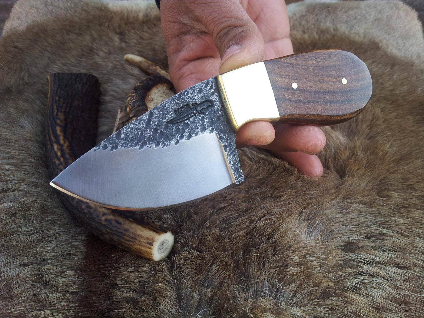 Rosewood handle with brass bolster on a custom deer skinning knife.
