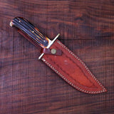 Detailed image of the sheath and full tang Damascus steel blade of the Western Bowie knife.