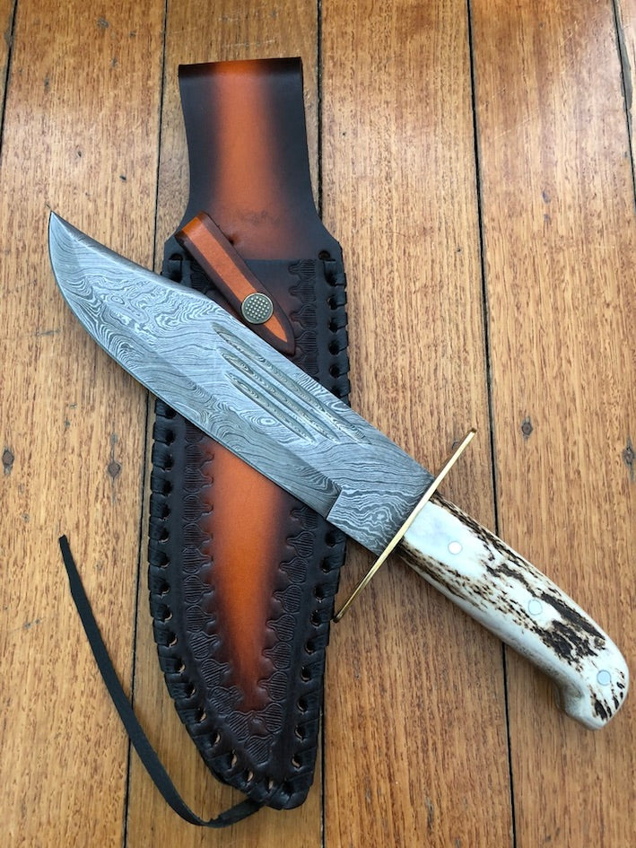 Custom handmade Western Bowie knife with 10-inch full tang Damascus steel blade and leather sheath.